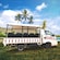 An open air truck parked on grass next to water in Saint Johns, Antigua